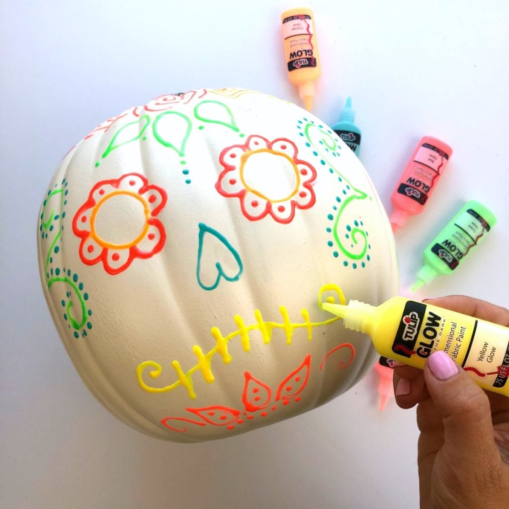 One our white pumpkins that's being painted with glow in the dark puffy paints Glow in the Dark Pumpkins