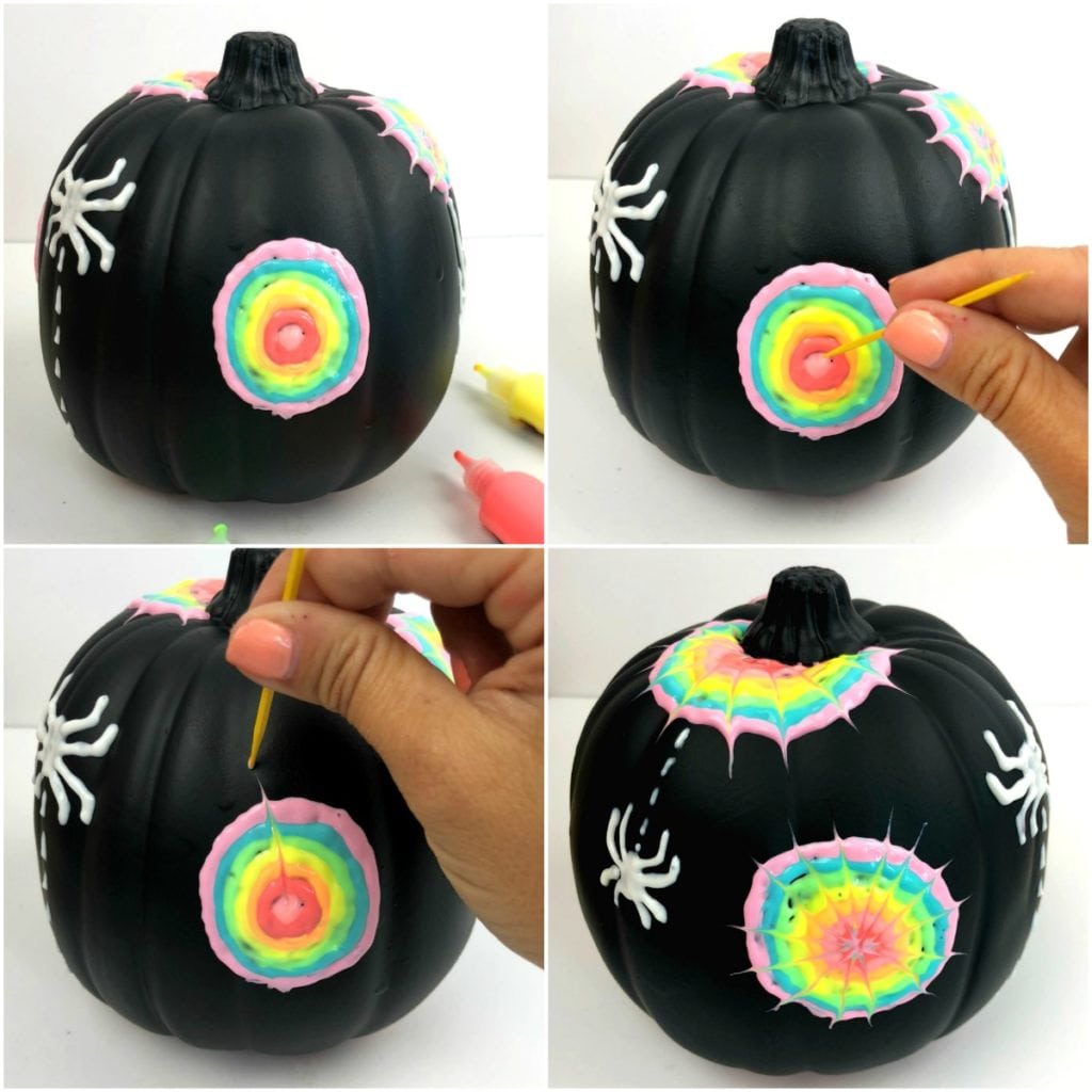 how to paint a spider web design on pumpkin - this one is a rainbow. First the design was painted on with the puffy paint in a bullseye shape, then a toothpick is being used to create spider web designs by starting in the middle and pulling out Glow in the dark pumpkins